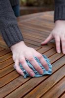 Wiping down, cleaning, patio table surface