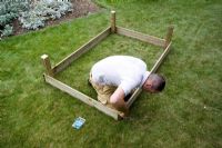 step by step, making a raised bed - attaching sides to corner posts