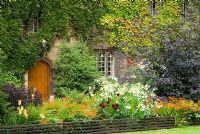 Wadham College garden, Oxford with Dahlia, Sambucus, Kniphofia, Nicotiana and Crocosmia