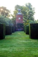Avenue of curving yew hedges leading to Clock Tower