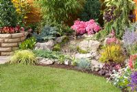 Colourful rockery with waterfall, raised bed and lawn by Ian Collins Garden Landscapes  - Southport Flower Show 2011