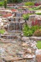 Stream cascading down rockery in the 'Glam Rock' garden by R. F. Showering Garden Design  - Southport Flower Show 2011