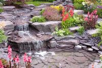 Stream cascading down rockery to pool in the 'Vintage Rose' garden by Chris Ashcroft Landscapes - Southport Flower Show 2011

