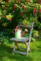 Fuschia genii with childs seat and watering can