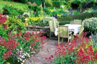 Dining table in upper terrace surrounded by Centranthus - Valerian - High Glanau Manor, Monmouthshire, Wales 