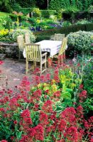 Dining table in upper terrace surrounded by Centranthus - Valerian - High Glanau Manor, Monmouthshire, Wales 
