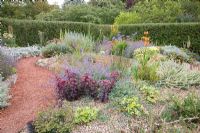 Mediterranean Garden - Eryngium, Agapanthus, Yucca, Phormium, Penstemon, Crocosmia in borders - Barnsdale Gardens