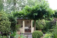 Summerhouse and Morus nigra - Mulberry tree in mediterranean style garden