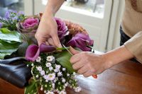 Woman making floral arrangement