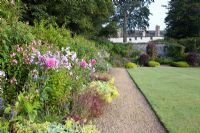 Walled  gardens and herbaceous borders lining paths - Bonython Estate Gardens, Cornwall
 