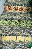 Steps with decorative tiles and pebbles