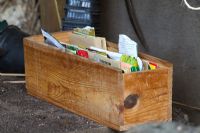 Wooden box stuffed with opened seed packets