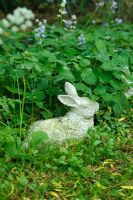 Rabbit ornament in wild garden
