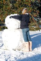 Child making a giant snow man. Gowan Cottage