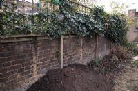 Preparing a border by adding topsoil. Before and after of London town garden