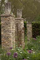 The Brewin Dolphin Garden with stone pillars topped with sculptures.    Contractor - Steve Swatton