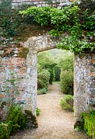 Doorway in brick wall between Vegetable Garden and Walled Garden - Rousham House, Bicester, Oxon, UK