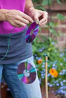Step-by-step - Creating string of CD's to keep birds away from vegetable beds