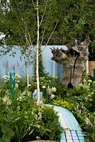 A garden designed for use by autistic children with a willow playhouse, hollow oak tree and bubble tubes - 'Corner of the World' - Silver medal winner - RHS Hampton Court Flower Show 2012 
 