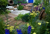 A garden for a young couple with a budget of £7000. Reclaimed scaffold boards and split logs predominate - 'Our First Home, Our First Garden' - Gold medal winner - RHS Hampton Court Flower Show 2012 
