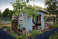 An old tin field shelter has been converted into a preserving kitchen - 'Preserving the Community' - Silver medal winner - RHS Hampton Court Flower Show 2012 
