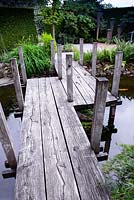 Wooden footbridge in Japanese style garden
