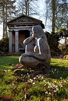 'Goddess of the Woods' statue and one of the two green oak temples in the Stumpery, Highgove Garden, February 2011. 