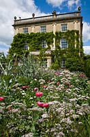 The Sundial Garden with poppies, Papaver somniferum, and Highgrove House, June 2011.