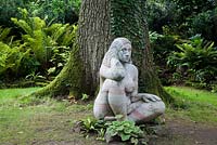 Sculpture of a Wood Nymph (Goddess of the Woods) sits in the meditative pose, in the Stumpery. Highgrove Garden, August 2007.