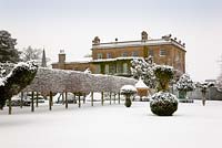 Oblique view of the west front with hedges and topiary at Highgrove, covered in snow, January 2010.  