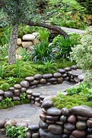 Moss mounds and decorative pebble waterfall in a traditional Japanese garden in Satoyama Life - Artisan Garden