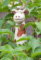 Cow ornament in foliage 
