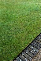Perfect lawn with green brick edging 