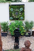 Floral, living clock on garden wall, 'The Wheels of Time Garden', Hampton Court Palace Flower show 2012