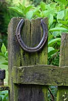 An old horseshoe nailed to a rustic wooden gate post - Sallowfield Cottage B&B, Norfolk