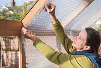 Step-by-step - Attaching bubble wrap to interior of greenhouse
