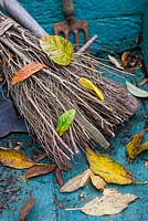 Traditional twig broom with Autumn leaves,