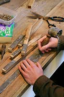 Making long lasting labels for snowdrops using thin strips of lead mounted on pressure treated stakes and scratching the names on with a bradawl