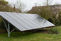 Bank of solar panels in rear garden of private dwelling, producing 4kw of electricity - Bredfield, Suffolk