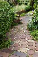 Path of terracotta ceramic tiles and bricks leading through garden - Ulla Molin 
 