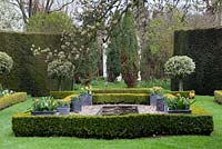 A formal pond edged with box hedging and standrad holly - The Dower House
