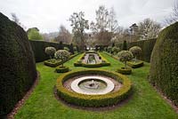 Formal ponds edged with box hedging and standard holly - The Dower House