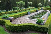 The formal pond edged with box hedging and Holly standards at The Dower House