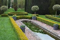 The formal pond edged with box hedging and holly standards at The Dower House