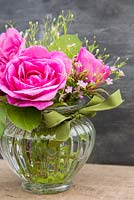 Flower arrangement in glass jar of Rosa 'Gertrude Jekyll' and Gypsophila 'Gypsy Rose'