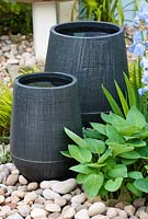 Ceramic containers by Lucy Smith filled with water at RHS Chelsea Flower Show 2009.
