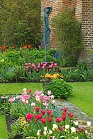 Sunken Garden, Tulipa, Myosotis, Primula, Sculpture by Carol Donaldson - Chenies Manor Gardens, Buckinghamshire, UK