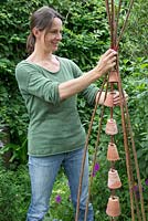Step by step -  Making a decoration from small terracotta pots to hang inside hazel wigwam - adding the decoration to the wigwam 
