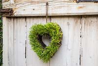 Step by Step - Turf heart hanging on wooden door