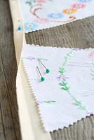 Step by step of making garden bunting with vintage linens and buttons - Pin the triangles up inside the fold of the ironed webbing